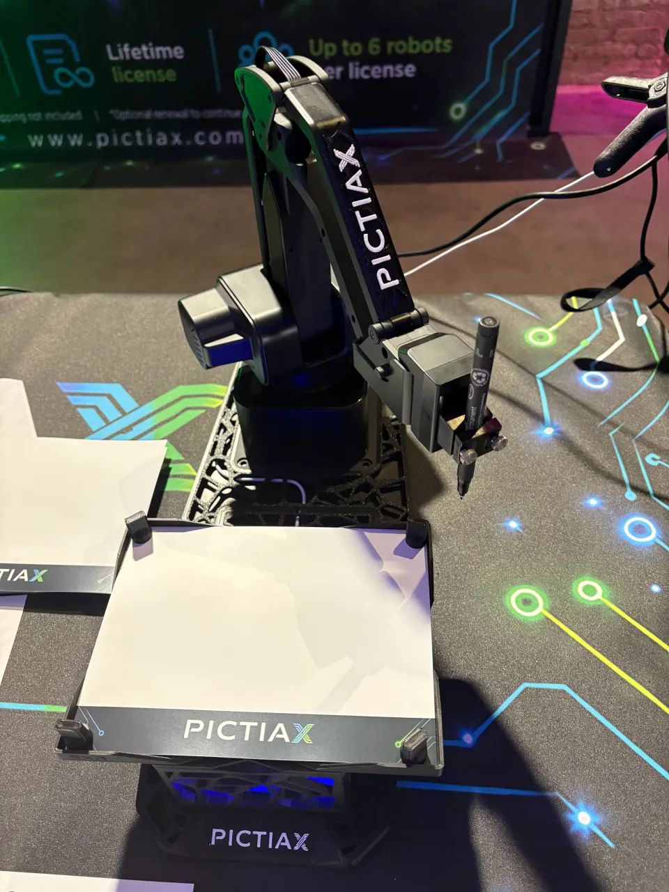 PictiaX® robot arm with the pen above the base and a blank sheet, ready to draw