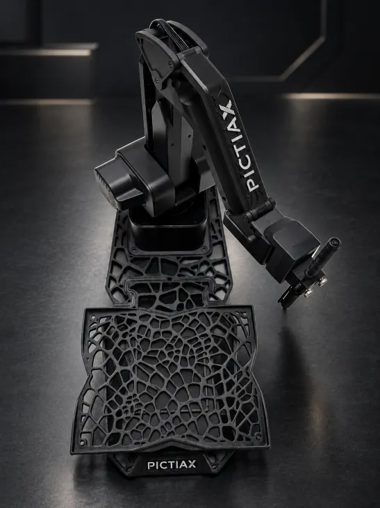 The PictiaX® robot arm on its base, with the cellular pattern frame fitted